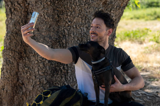istock man with dog taking a selfie 2187270689