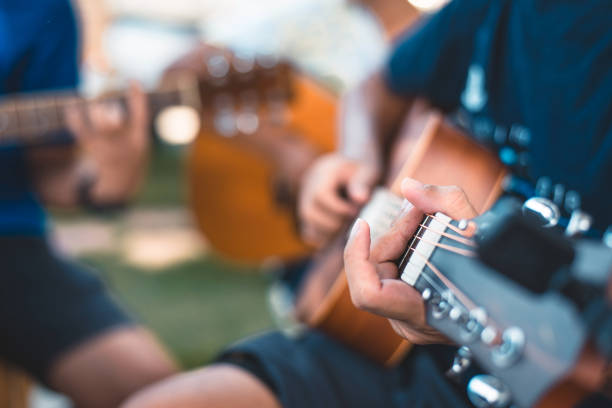Close-up of hands playing acoustic guitars