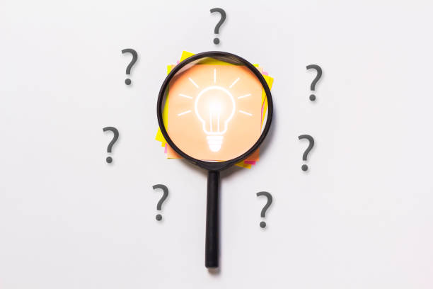 istock Magnifying glass, focus light bulb icon and question mark on note paper, questioning and problem solving concept 2187271494