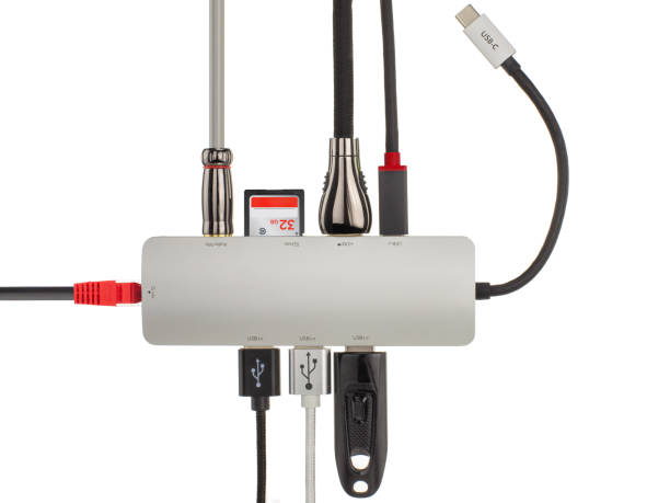Close up of a sleek USB hub with various connected cables and devices, illustrating technology and connectivity.