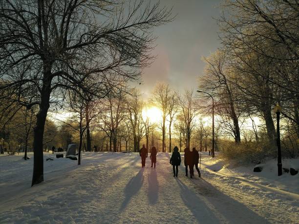 istock People walking on snowy path at sunset 2187274428