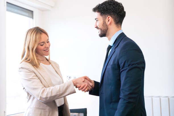 istock Business professionals shaking hands in modern office setting. 2187275529