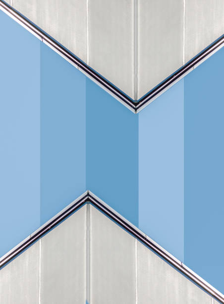 corner of a concrete building with windows