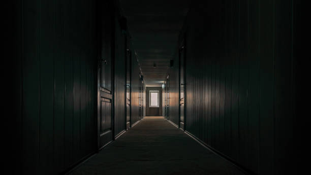istock gloomy dark corridor of an empty hotel without people during quarantine 2187277803