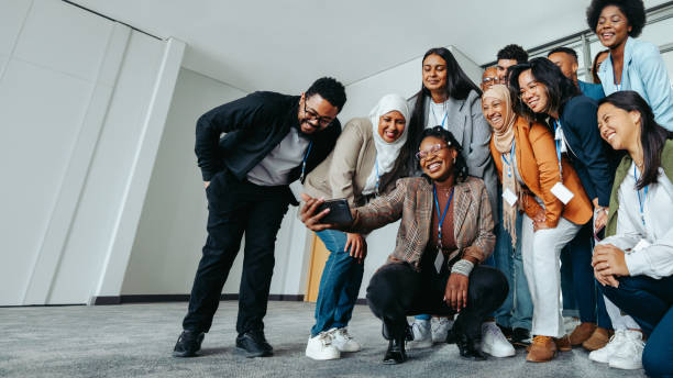 istock Diverse group of colleagues taking a selfie during a team bonding session at the office 2187279505