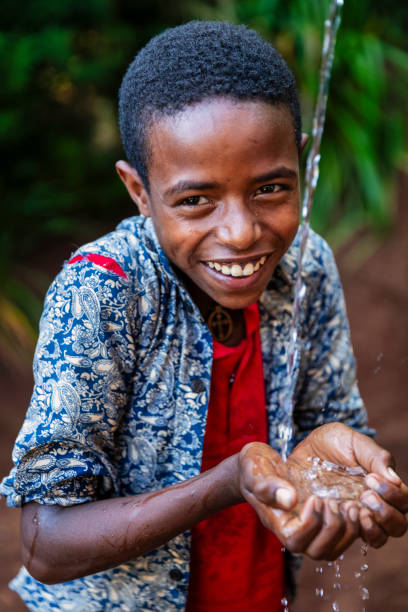 istock African young boy drinking fresh water, East Africa 2187279836