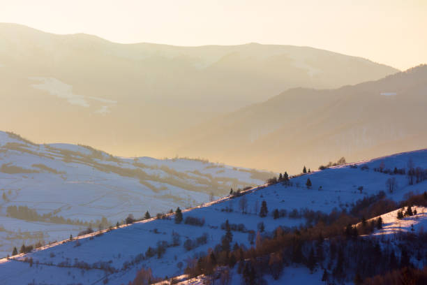 mountainous countryside landscape in winter. sunny morning. snow covered hills