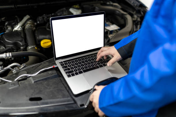istock Technician using a blank screen laptop to diagnose issues under the hood of a car in an auto repair shop 2187281387