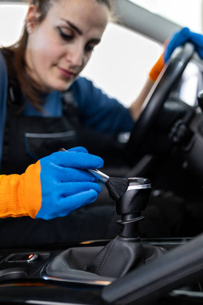 istock Car interior cleaning with a focus on the gear shift by a detailed-oriented individual using gloves 2187281399