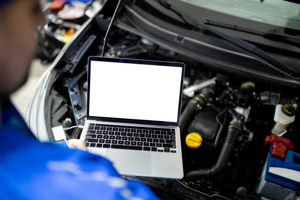 istock Mechanic using blank screen laptop to diagnose car engine issues in auto repair shop during daytime 2187281429
