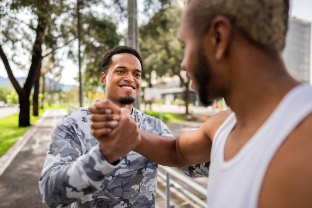 Friends greeting each other at public park