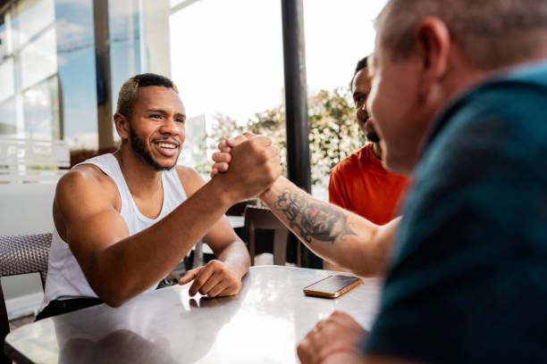 Friends shaking hands at restaurant