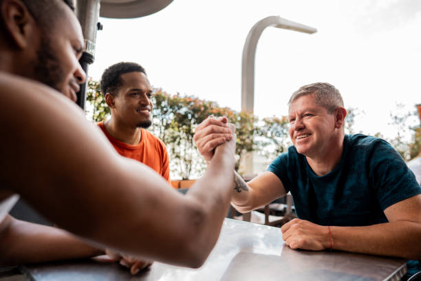 Friends shaking hands at restaurant