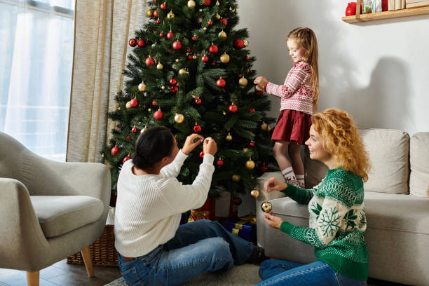 istock Celebrating holidays with a multicultural LGBT family decorating their tree 2187283264