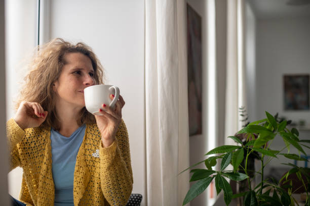 istock Serene middle-aged woman enjoying at home 2187283609