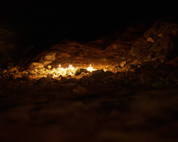istock Ancient ruin of roman cave with vegetation and illuminated candles. 3D render. 2187284502