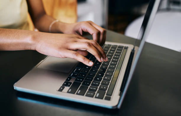 istock Close-Up of Young Woman's Hands Typing on a Laptop 2187285135