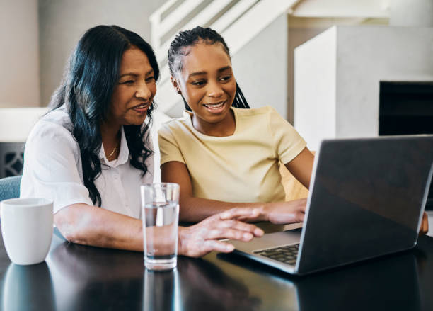 istock Mother and Daughter Looking at a Laptop Screen Together 2187285139