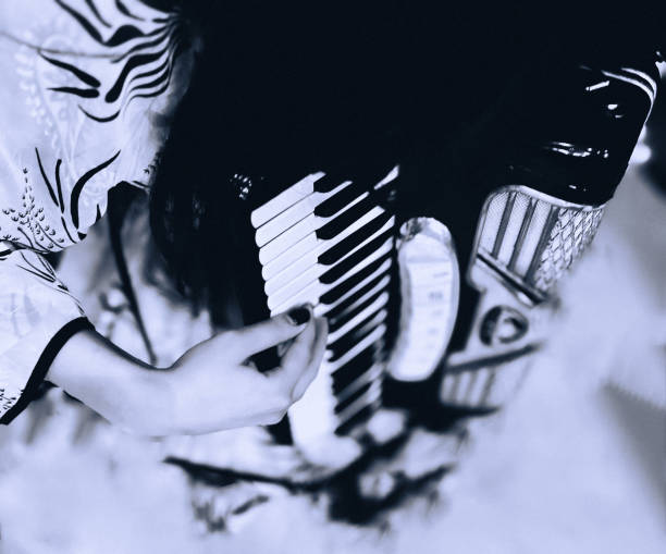 istock woman playing accordion on stage no face just hands 2187286996