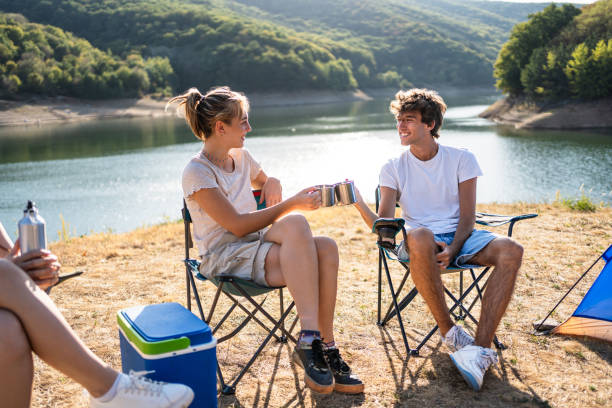 istock Friends enjoying camping by the lake 2187287540