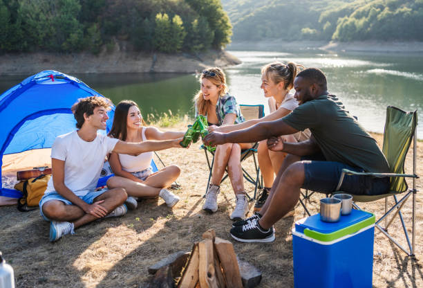 istock Friends toast while camping by the lake 2187287850