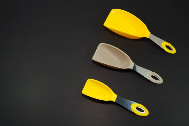 Measuring scoops together with dark background close-up view group of objects
