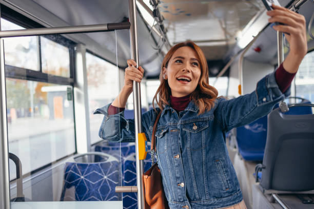istock Young woman taking a selfie while riding the bus 2187291349