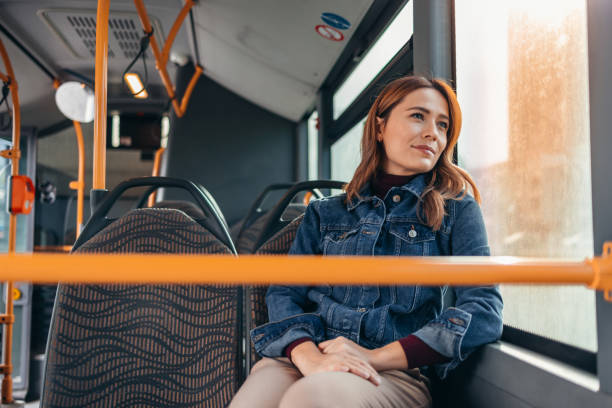 istock Young woman looking out the window while commuting by bus 2187291372