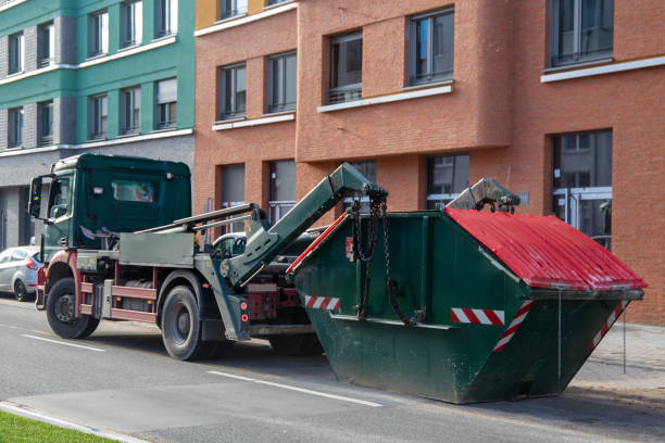 istock Container service: Lorry with skip container in front of a new apartment building 2187294626