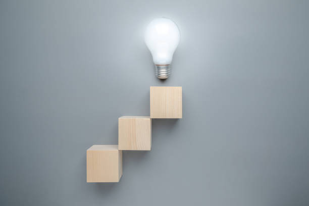 istock Light bulb at the top of the step stairs 2187297541