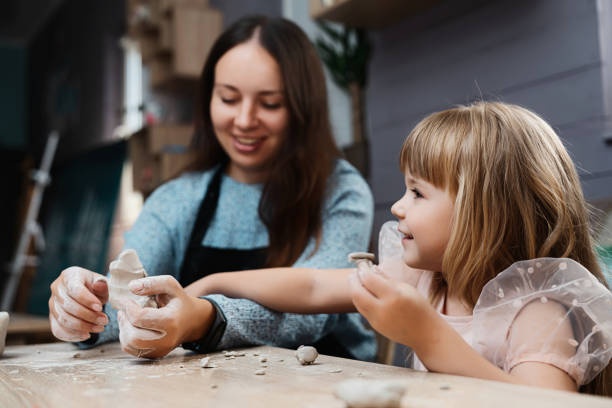 istock A mother and daughter enjoy clay modeling together in a cozy studio 2187298488