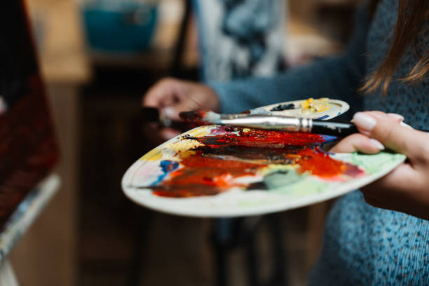 istock Artist mixing vibrant colors on a palette in a creative studio setting 2187299140