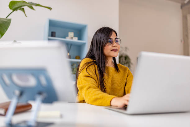 istock Focused woman working in bright modern office space 2187299687