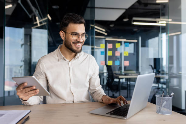 istock Professional man working at desk with laptop and tablet 2187300802