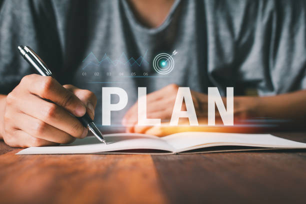 Hand using pen of Teamwork drives success Planning strategies, setting goals, and targeting achievements to turn ideas into actionable results for the future.