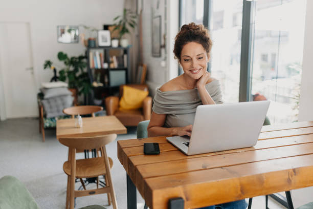 istock Woman Working on Laptop in Cozy Interior Space 2187301237