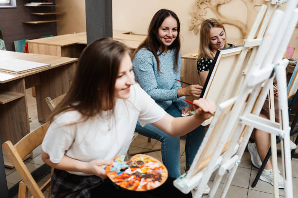 istock Artistic workshop with students painting and learning in a cozy studio 2187301912