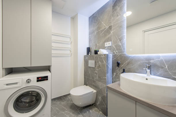 istock Bright Elegant Modern Luxury Home Bathroom Interior Design With White Sink. Marble Gray Walls, Mirror and Faucet. LED Mirror Lights. Heater. Shower, Tile Floor and Walls. Laundry 2187302487