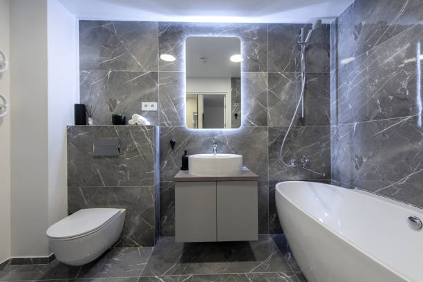 istock Bright Elegant Modern Luxury Home Bathroom Interior Design With White Sink. Marble Gray Walls, Mirror and Faucet. LED Mirror Lights. Bath Area, Tile Floor and Walls 2187302534