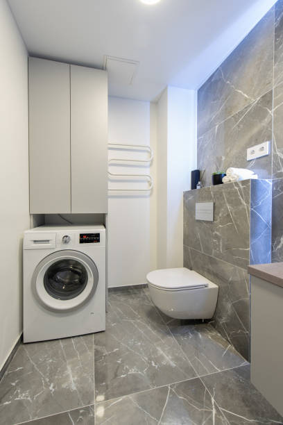istock Bright Elegant Modern Luxury Home Bathroom Interior Design With White Sink. Marble Gray Walls, Mirror and Faucet. LED Mirror Lights. Heater. Shower, Tile Floor and Walls. Laundry 2187302582