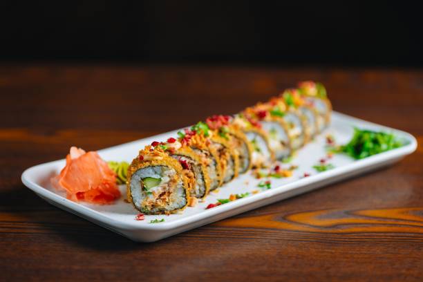 istock Sushi roll garnished with ginger and wasabi on a plate. 2187303458