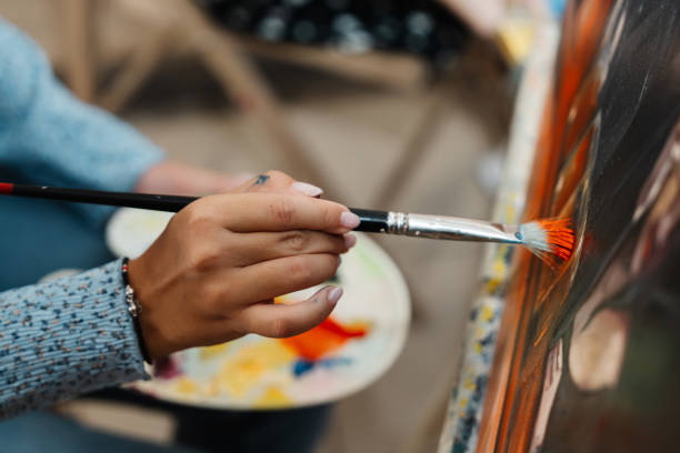 istock Creative artist engaged in painting with vibrant colors in a studio setting 2187304692