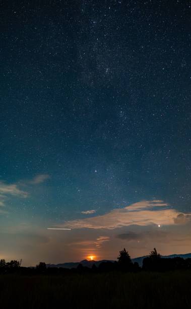 istock Starry night sky with glowing sunset over mountains 2187304695