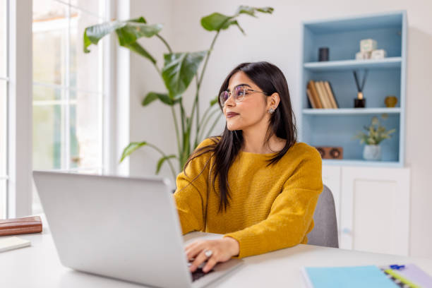 istock Woman working on laptop in modern bright home office 2187306608