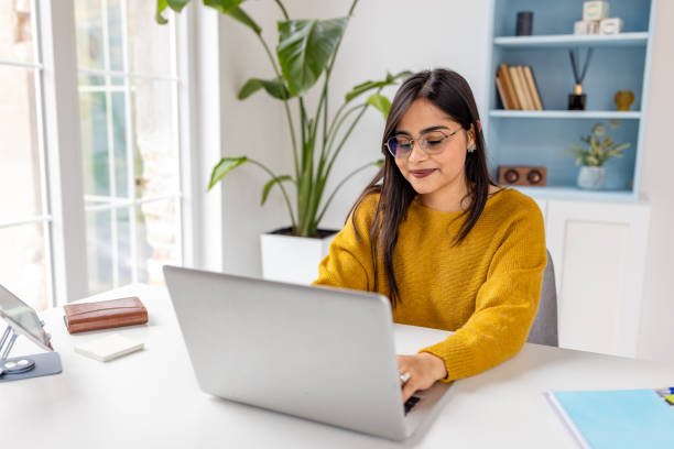 istock Woman working on laptop in modern home office space 2187306627