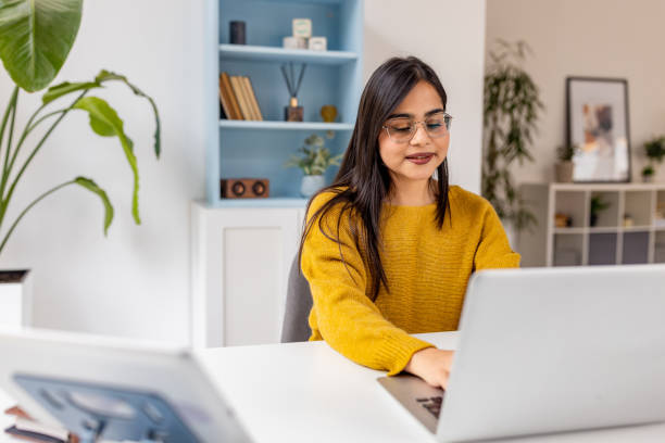 istock Woman works diligently on laptop in cozy office space. 2187306673