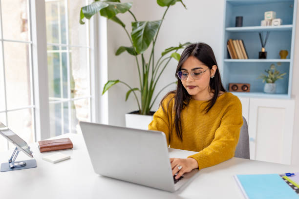 istock Young lady engaged in work at modern desk with plants 2187306730