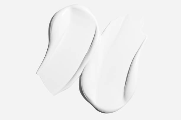 Smears of white cosmetic cream on a light background