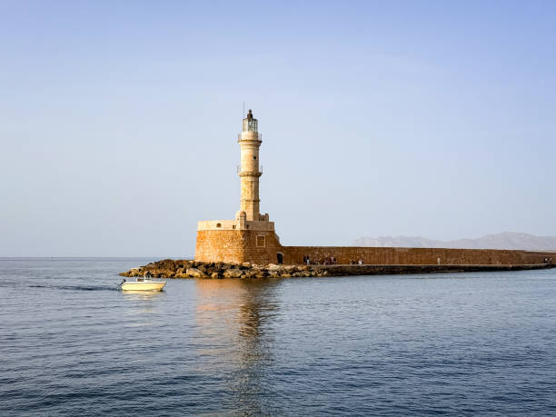 Greece, Crete, Rethymno, Venetian Harbour, lighthouse seen through the passagewayin the Old Customs House