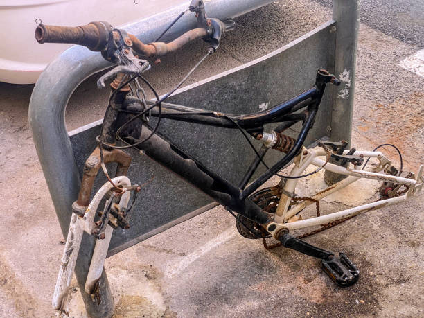 Rusty bicycle body left in the street